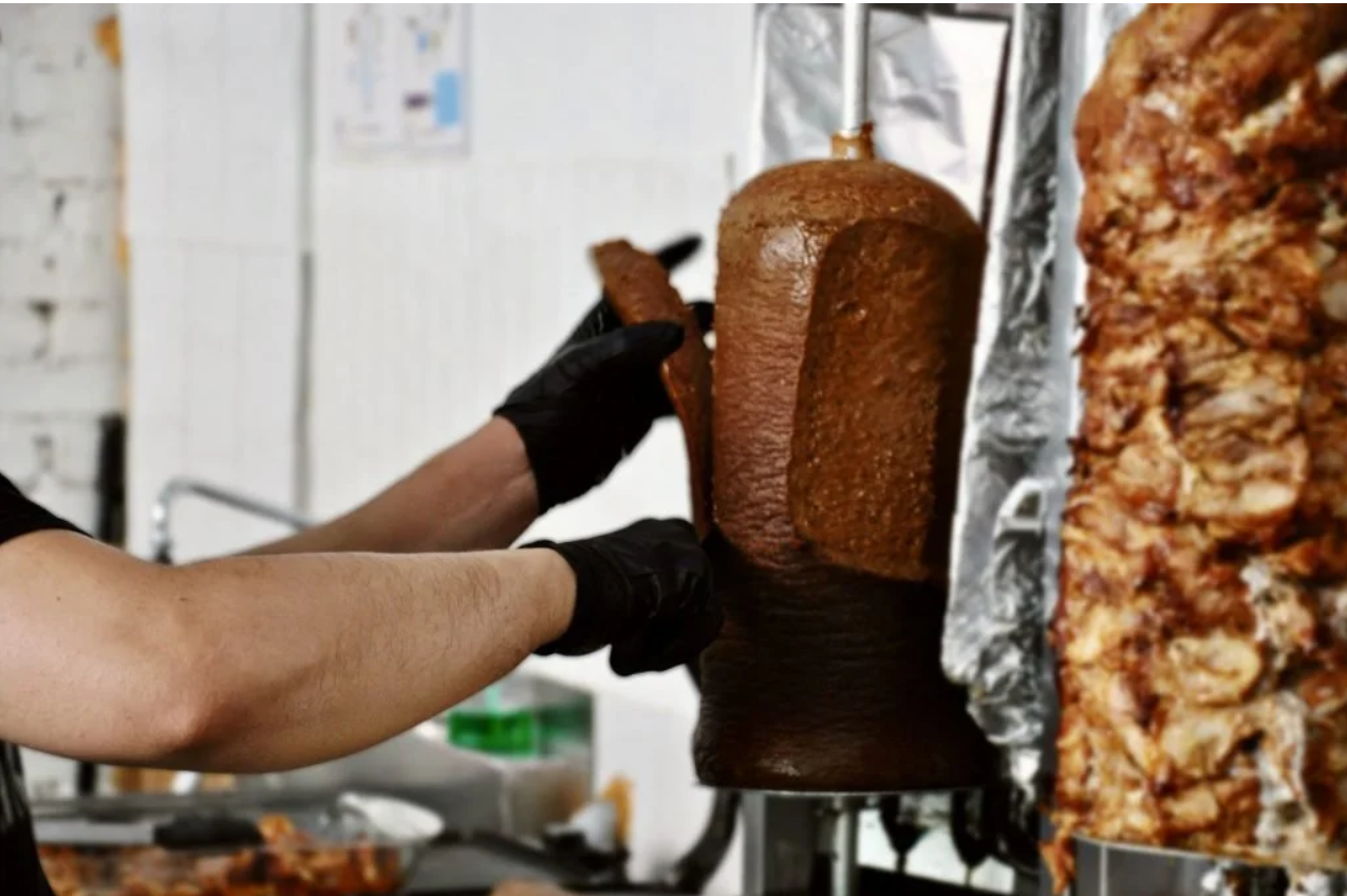 Shaving meat straight off the shawarma spit
